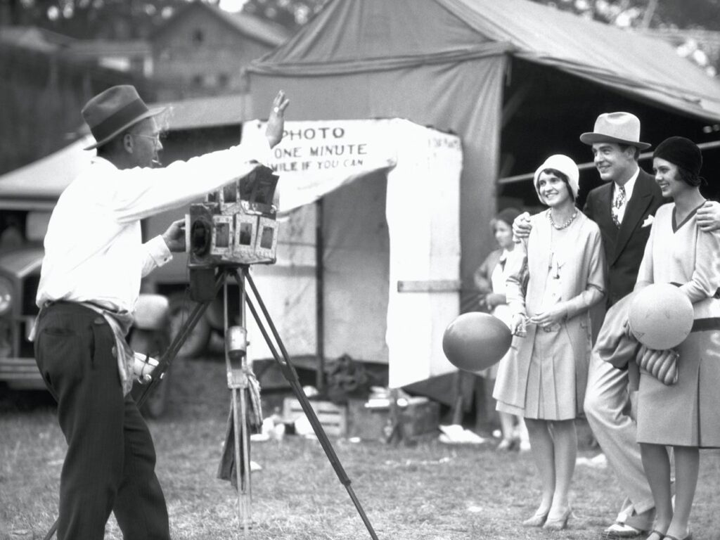 Young adults having their picture taken at a fair.