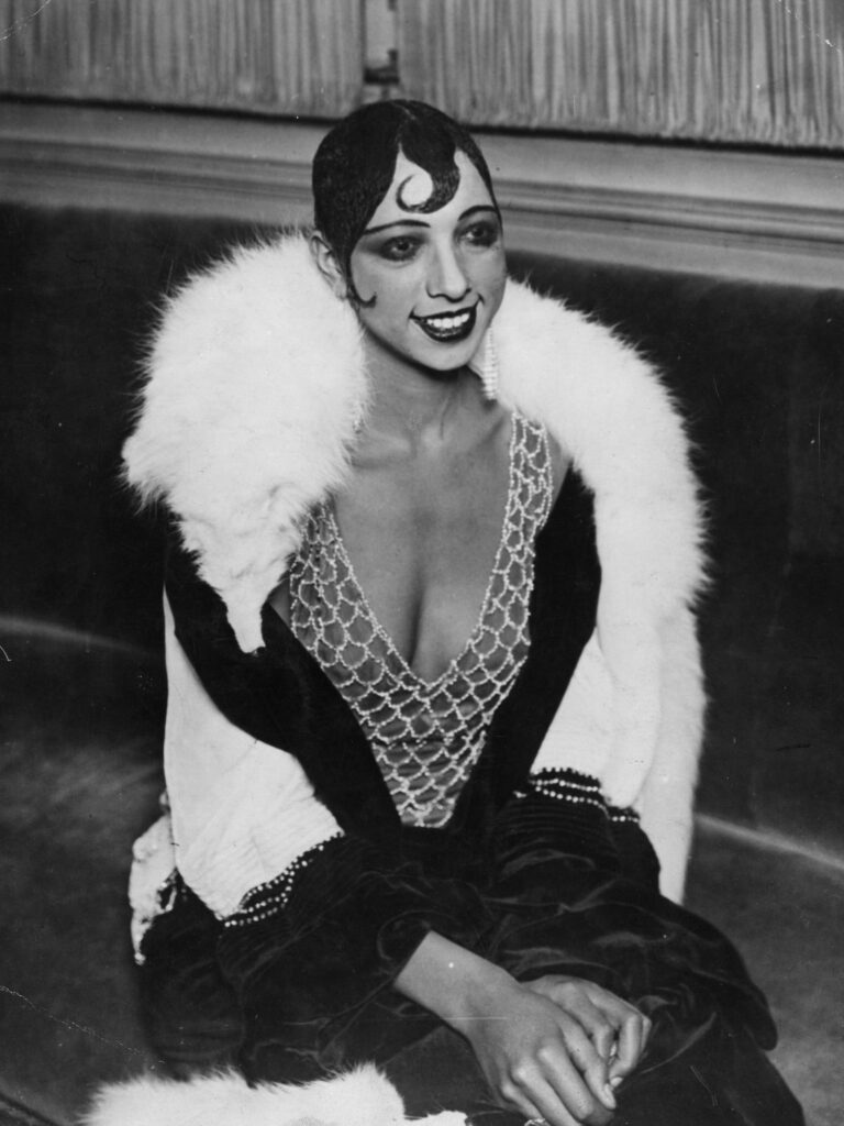 Women with white fur and lavish makeup.