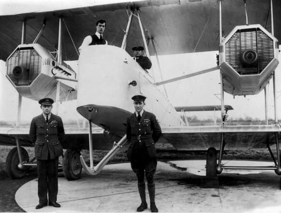 A black and white image of two men standing in front of their airplane before taking off for the cross-continental journey.